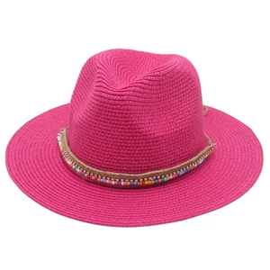 Detailed texture of rose pink straw hat with colorful beads and rhinestone decoration