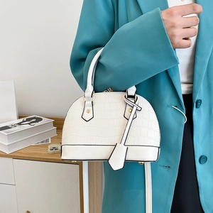 Vintage white shell-shaped handbag with crocodile texture and long shoulder strap