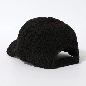 Detail of black faux shearling baseball cap showing soft texture and adjustable back
