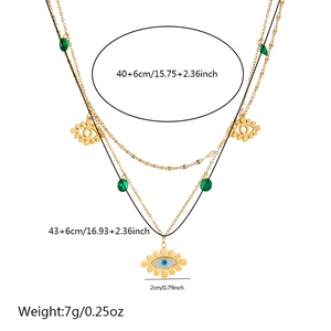 Detail shot of gold layered necklace with eye pendant, green beads and size dimensions