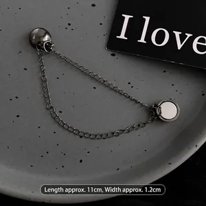 Macro detail of gunmetal magnetic chain buckle for T-shirt length adjustment
