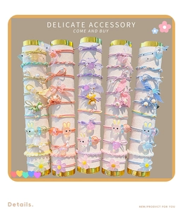 Detailed view of colorful macaron hair ties with cute resin bunny and floral charms
