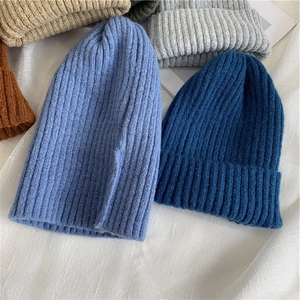 Japanese style ribbed knit beanies in various colors on a soft white background