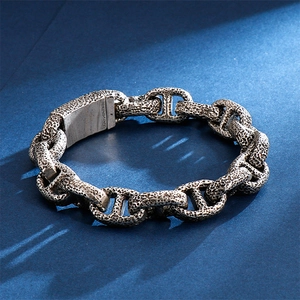 Macro detail of men's vintage distressed steel chain bracelet with rugged texture