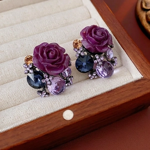Vintage style purple resin rose stud earrings with colorful crystals in a jewelry box