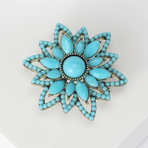 Vintage Turkish flower brooch with turquoise beads and bronze finish on white background