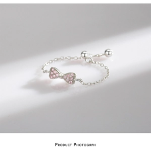 Adjustable silver chain ring featuring a 3D bow tied with sparkling pink zircon stones