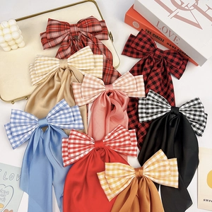 Plaid bow hair clips in multiple colors like red and blue for a sweet preppy style
