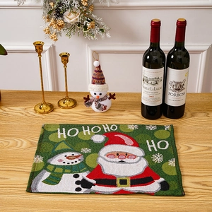 Close-up of festive knitted Santa placemat on wooden table with holiday decor accents
