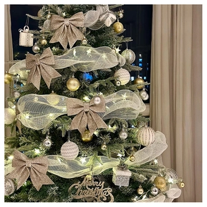 Detail of Christmas tree decorated with champagne gold bows, net ribbons and ornaments