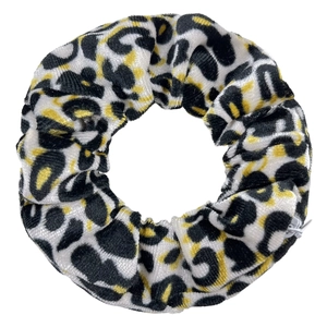 Macro detail of velvet hair scrunchie with classic leopard print and soft texture