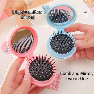 Compact folding hairbrush with integrated mirror in pastel pink and blue colors