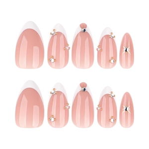 French tip almond press-on nails in nude pink with white borders and rhinestones