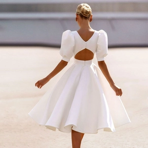 Elegant white satin wedding dress with puff sleeves and backless cutout detail