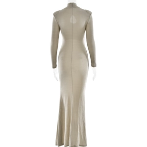 Close-up of elegant beige fishtail dress with back cutout and high neckline detail