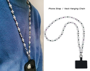 Detail of floral beaded phone strap with white pearls and metal clasp on blue sweater