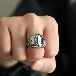 Detailed view of silver men's religious ring with Virgin Mary relief and cubic zirconia