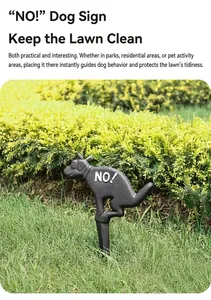 Détail d'un panneau de jardin en fonte pour chien avec texte NO! sur une pelouse verte