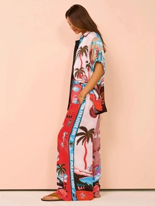 Detail of tropical print two-piece summer set with palm trees and artistic typography