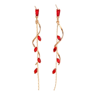 Detail of elegant gold tassel earrings with red marquise-cut zircon stones on white backdrop