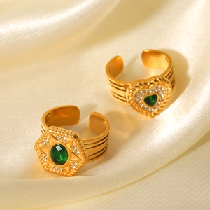 Vintage gold adjustable rings with green heart and star zirconia on silk background