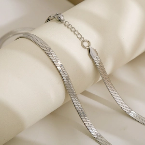 Close-up of silver stainless steel flat snake chain with lobster clasp and extender
