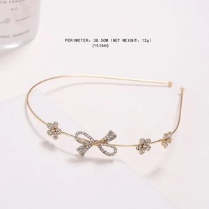 Vintage gold headband featuring crystal butterflies and small flowers on white background