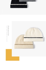 Detail of chunky knit fisherman hats in neutral colors with stylish contrast striped brims