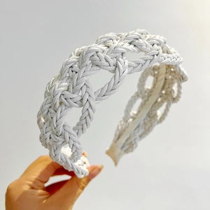 Close-up of white twisted braided leather headband showing intricate handmade texture