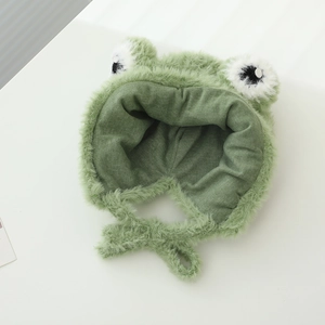 Cute green plush frog earflap hat for babies with black and white eyes and tie-up design