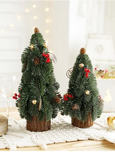 Close-up of mini artificial Christmas trees with red berries and wooden base decor