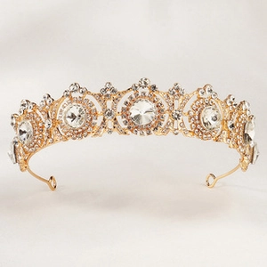 Detailed view of luxury gold bridal crown with crystal flower patterns and fixing loops