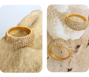 Close-up of wide gold titanium steel ring pavé-set with clear Czech crystals on natural stones