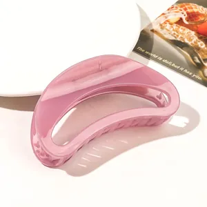 Macro detail of a large translucent pink claw clip with smooth acrylic finish and sturdy teeth