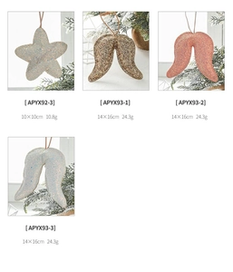 Detailed view of glittering star and wing Christmas ornaments with size and weight specs