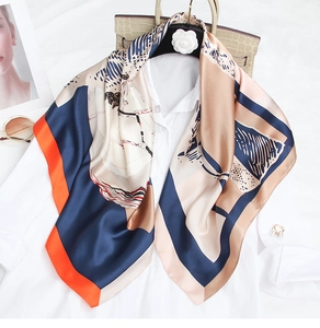 Artistic printed silk scarf styled over a white shirt with elegant accessories