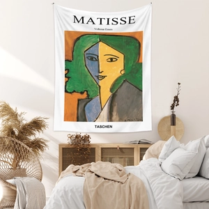 Detail of Matisse style wall tapestry hanging in a cozy bedroom with natural light