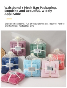 Close-up of coral fleece towel set with waffle texture in gift mesh bag packaging
