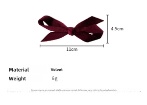 Detail view of burgundy velvet bow hair clip with dimensions 11cm x 4.5cm and 6g weight