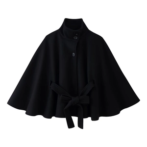 Detail view of black stand collar cloak coat featuring button closure and tied waist belt