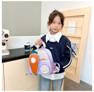 Detail of purple kid's backpack with orange carrot 3D decor and rabbit patch