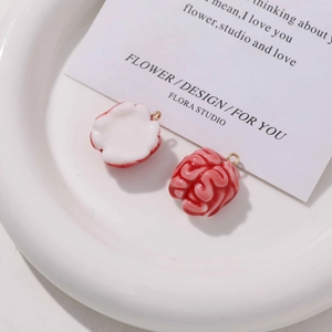 Macro shot of creative resin brain charms with realistic texture and gold metal rings