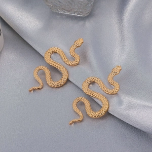 Retro punk gold 3D snake earrings in a sleek S-shaped design on silver silk background