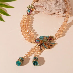 Detail of double-layer beaded necklace with champagne crystals and peacock gemstone pendant