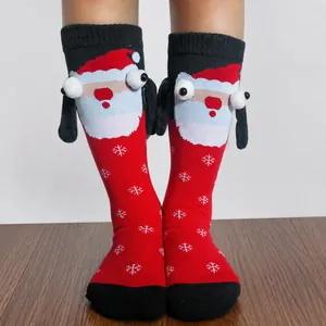 Detail showing Christmas themed magnetic hand-holding socks with 3D Santa Claus elements