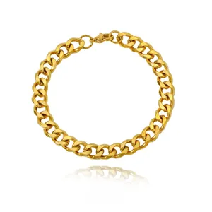 Detail of a polished gold curb link chain bracelet with a secure lobster clasp