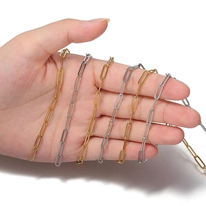 Polished 304 stainless steel paperclip link chain in gold and silver held by a model