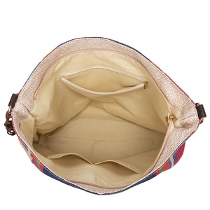 Detail view of woven shoulder bag interior with beige lining and multi-pocket storage