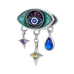 Macro detail of Evil Eye charm with colorful enamel inlay and hanging star pendants