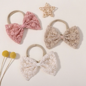 Three-piece baby headband set with lace daisy embroidery in pink, beige, and white colors